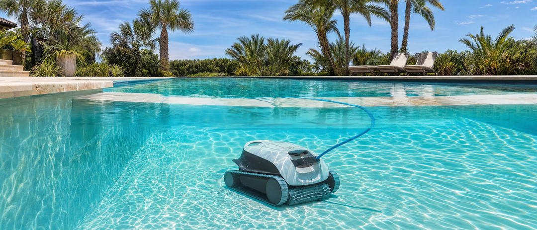 Robotic pool cleaner working in clear turquoise water