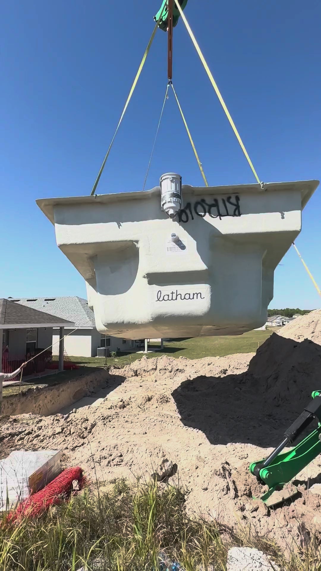 A Latham fiberglass pool shell lowered by crane into the excavation by the Cool Pool of Florida crew